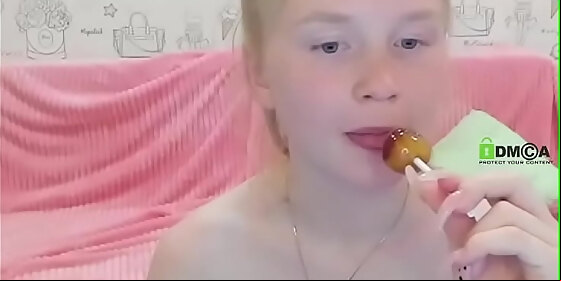 young girl sucking lollipop