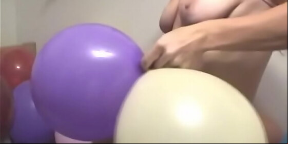 chick strips and rubs balloons on her tits